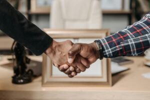 pexels-photo-8112091-8112091 Close-up of a handshake between two professionals in an office environment.