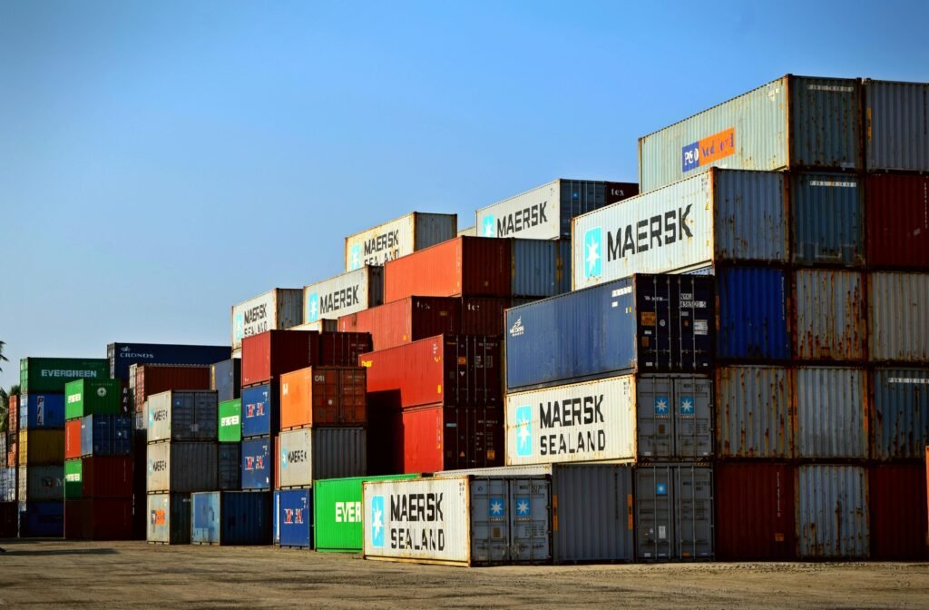 pexels-photo-906494-906494 Colorful stacked shipping containers at a port exemplify global logistics.